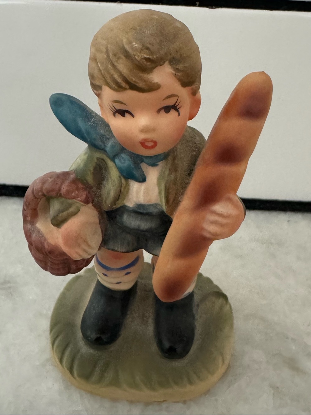 Vintage ceramic figurine is a Napcoware "Boy with Baguette"